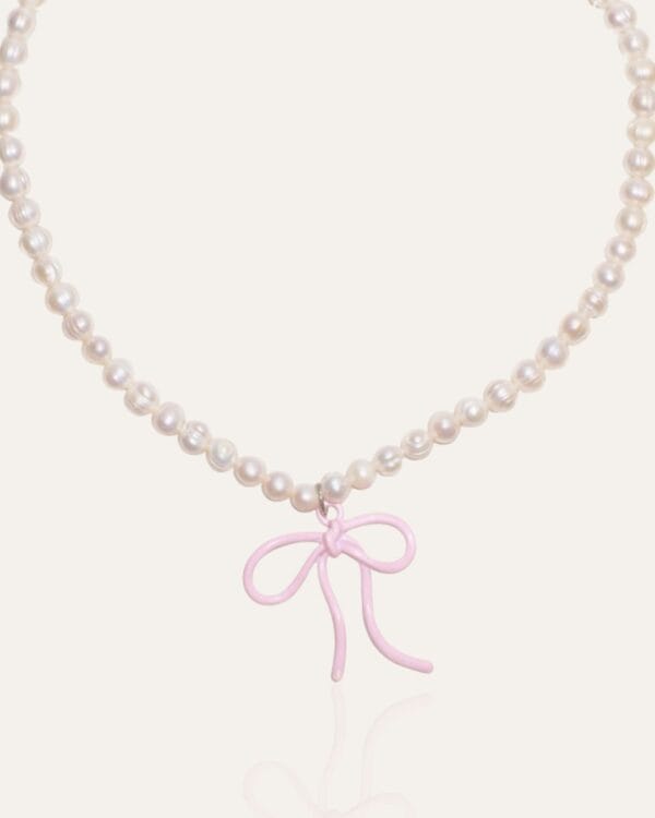 Pearl necklace with pink bow charm