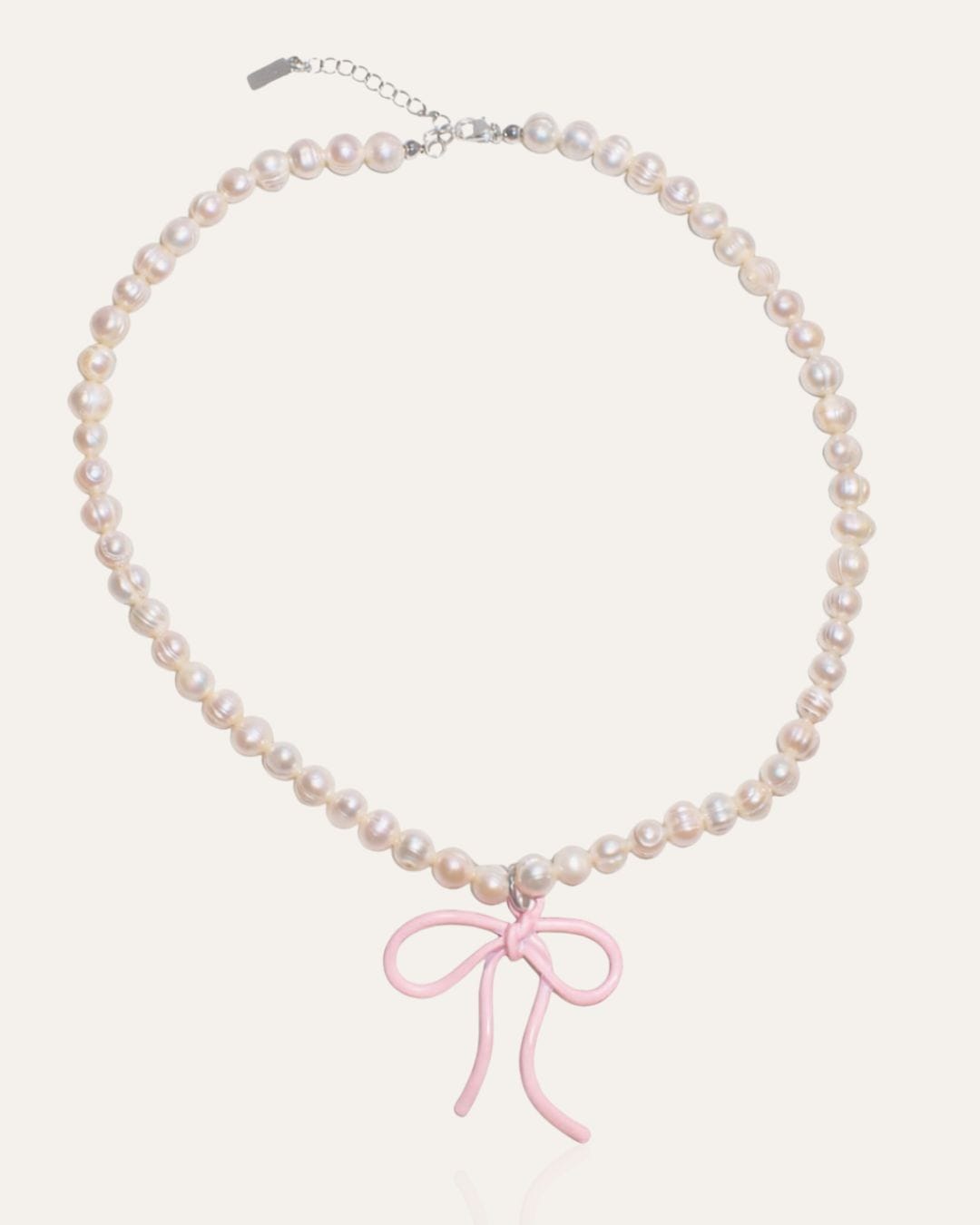 Pearl necklace with pink bow charm