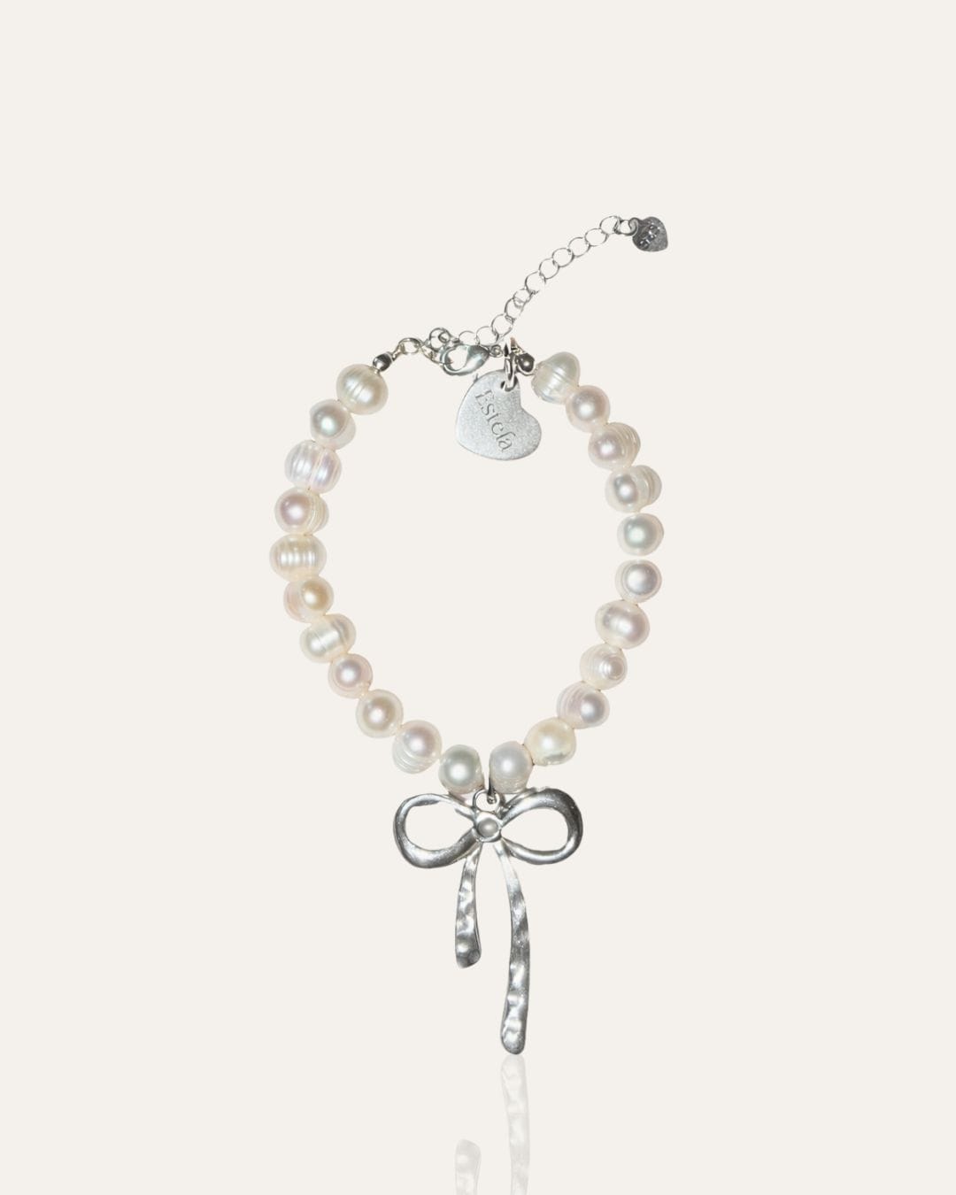 Pearl bracelet with silver bow charm