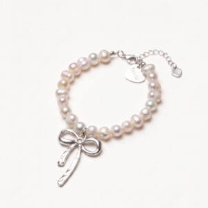 Pearl bracelet with silver bow charm