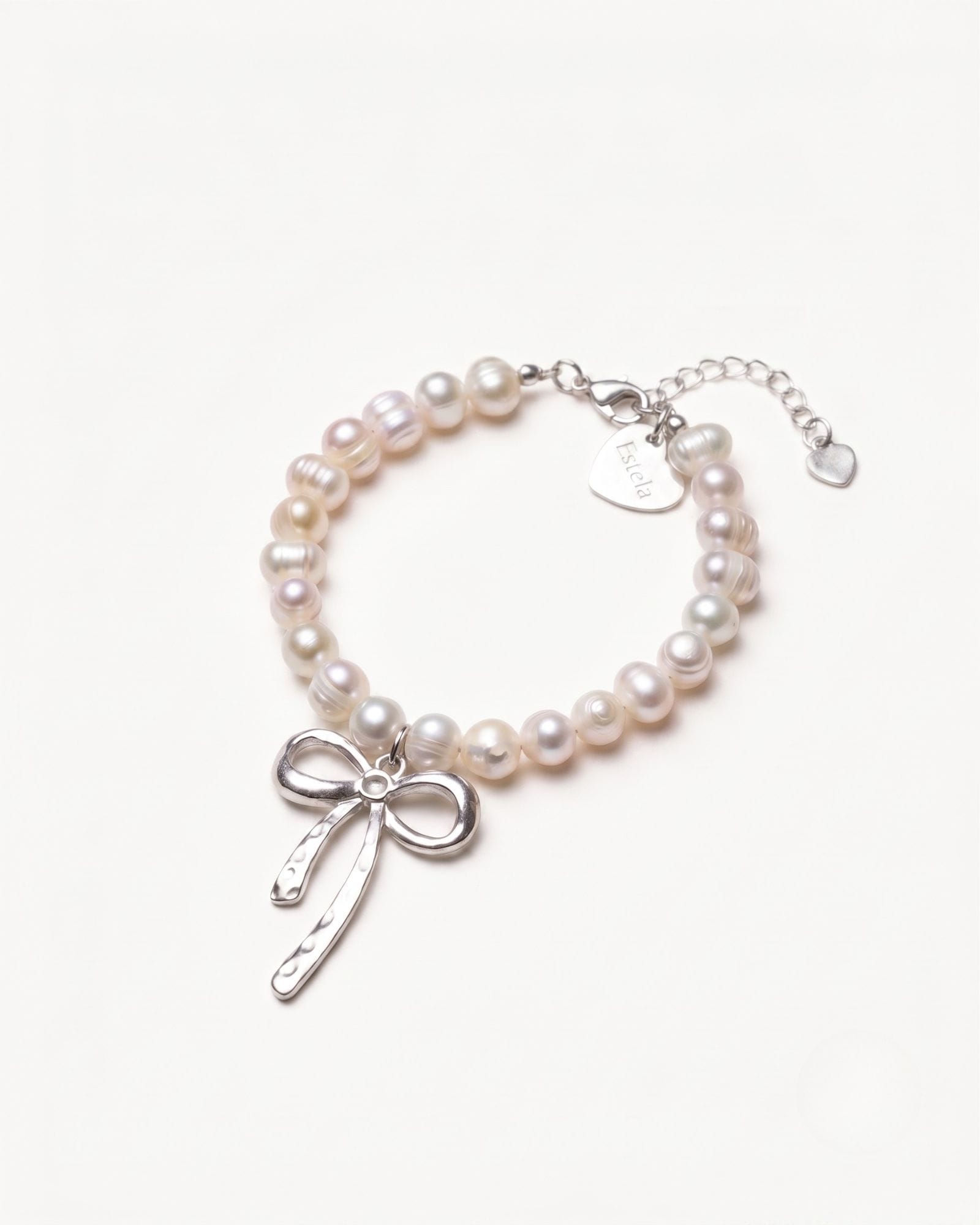 Pearl bracelet with silver bow charm
