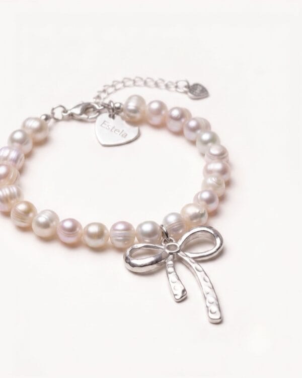 Pearl bracelet with silver bow charm