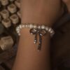 Pearl bracelet with silver bow charm