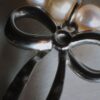 Pearl bracelet with silver bow charm
