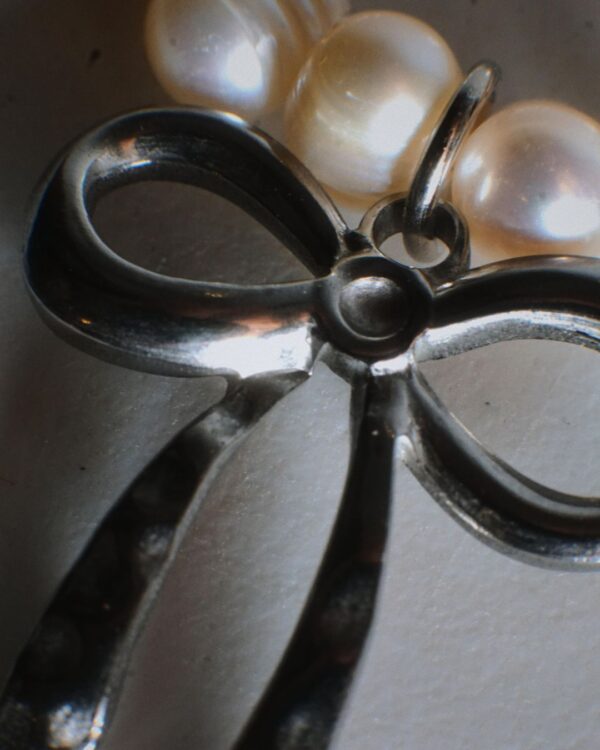 Pearl bracelet with silver bow charm