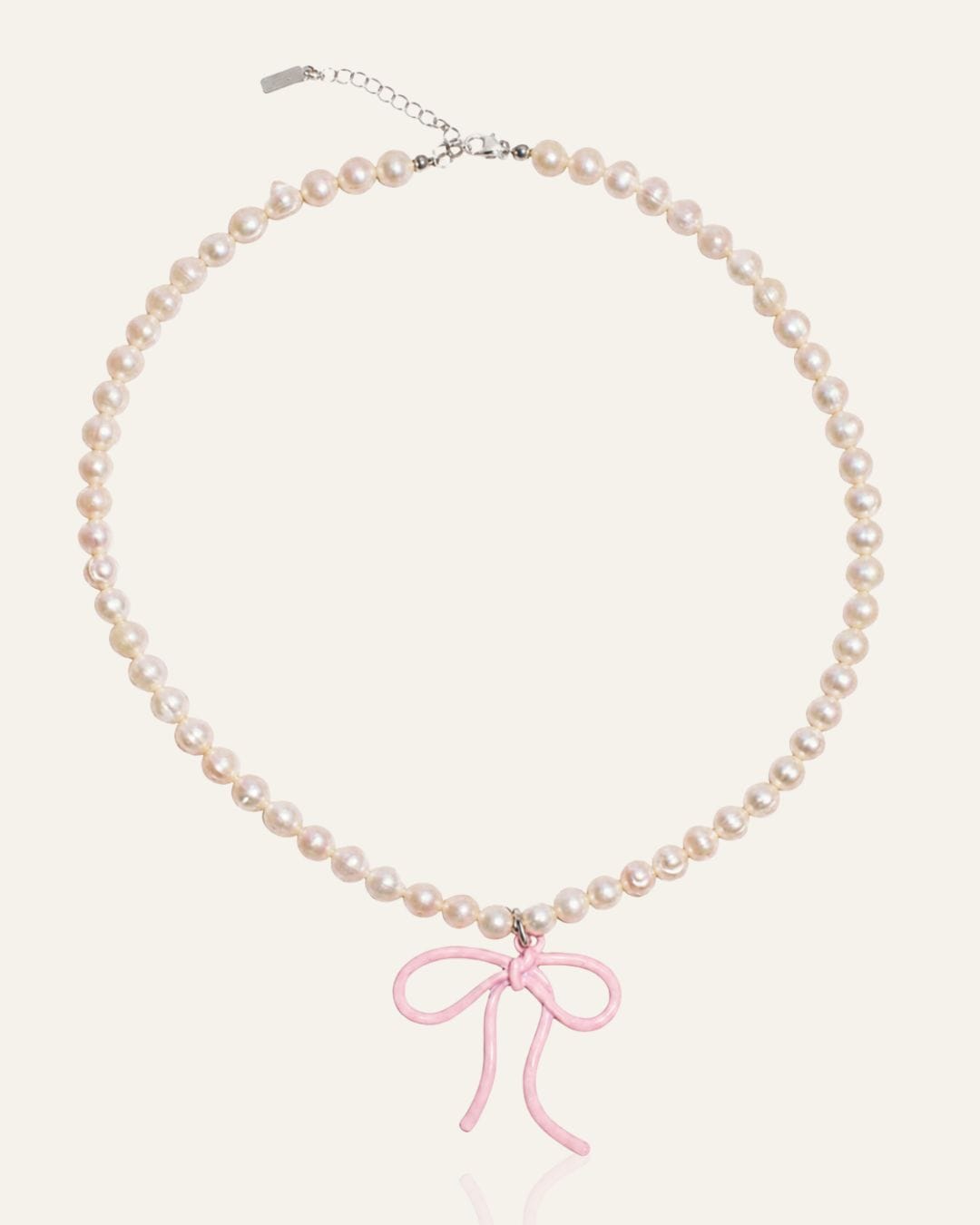 Pearl necklace with pink bow charm